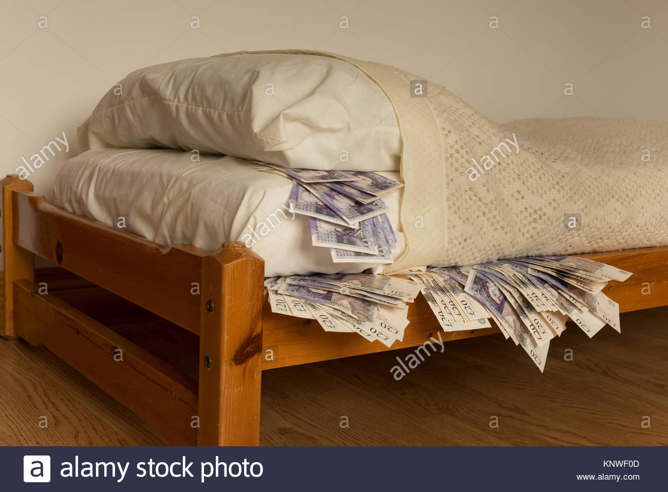 a-ready-supply-of-stashed-cash-money-banknotes-under-the-bed-mattress-KNWF0D.jpg